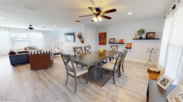 dining area with ceiling fan and light wood-type flooring