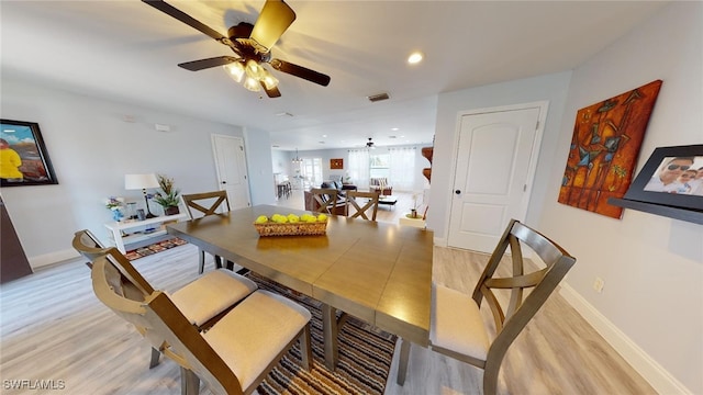 dining space featuring ceiling fan and light hardwood / wood-style flooring