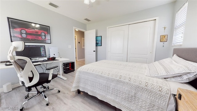 bedroom featuring light wood-type flooring and a closet