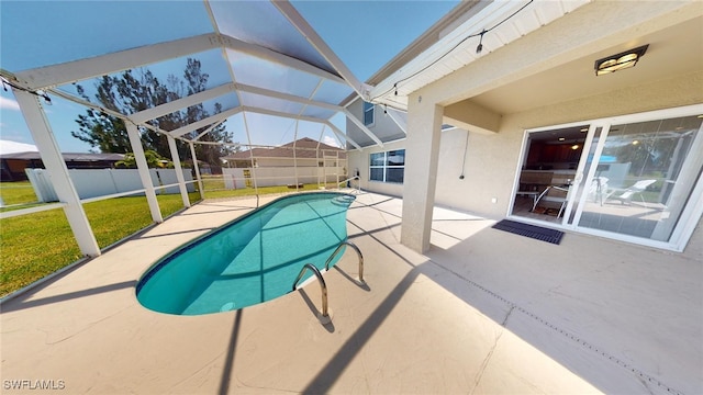 view of swimming pool featuring a lanai, a yard, and a patio