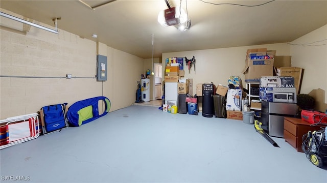 garage featuring water heater, a garage door opener, and electric panel