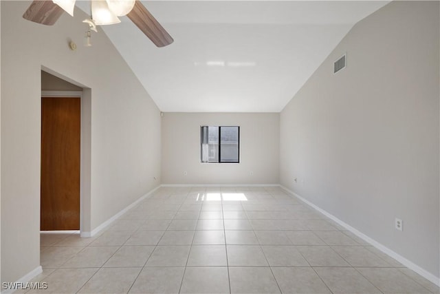 empty room with ceiling fan, light tile patterned flooring, and vaulted ceiling