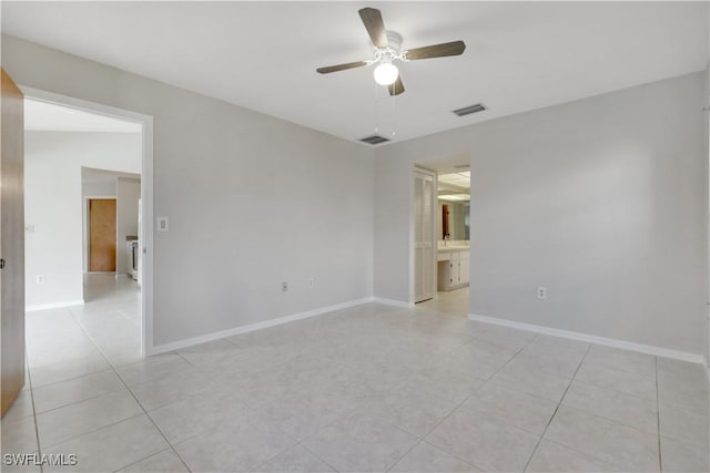 tiled spare room with ceiling fan