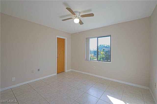 spare room featuring ceiling fan and light tile patterned floors