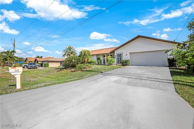 ranch-style house with a garage and a front lawn