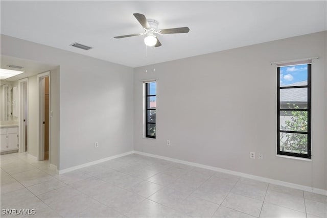 empty room featuring ceiling fan and light tile patterned floors