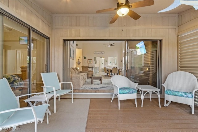 sunroom / solarium featuring ceiling fan