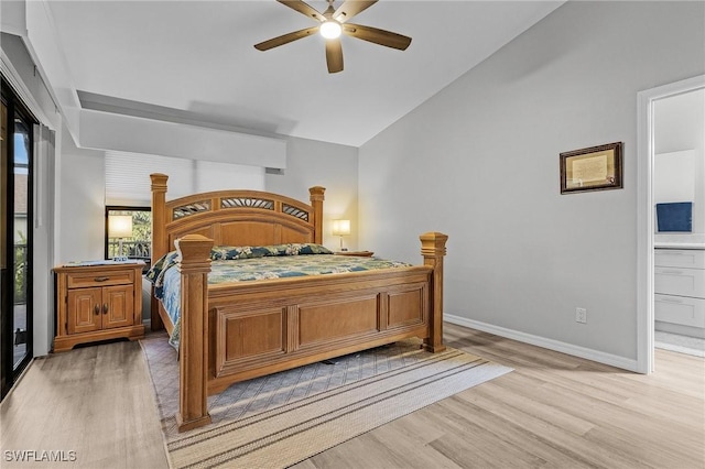 bedroom featuring wood-type flooring, connected bathroom, vaulted ceiling, and ceiling fan