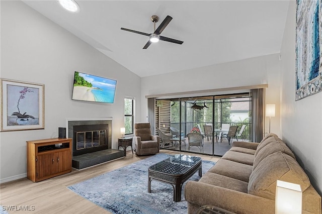 living room with ceiling fan, high vaulted ceiling, and light wood-type flooring