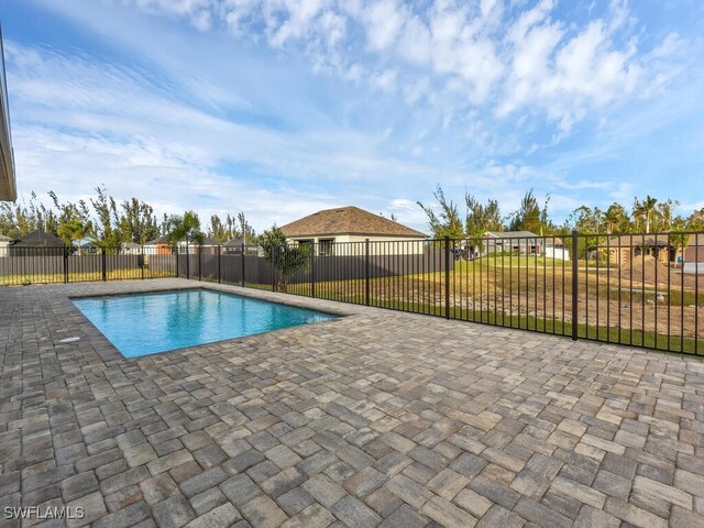 view of pool featuring a yard and a patio