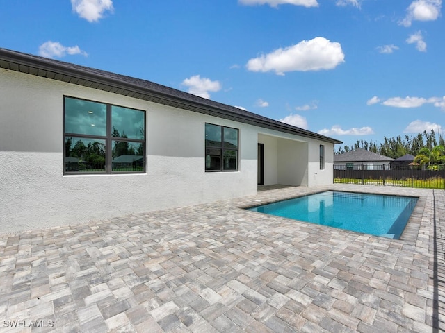 view of swimming pool featuring a fenced in pool, a patio, and fence