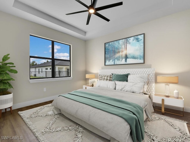 bedroom featuring hardwood / wood-style floors and ceiling fan