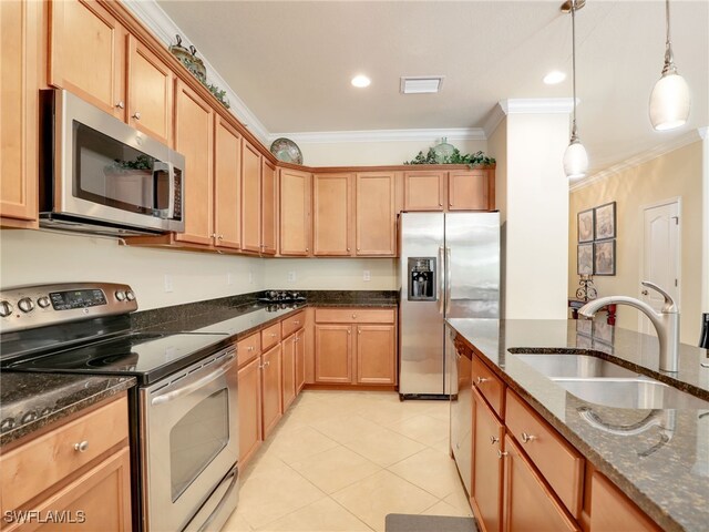 kitchen with appliances with stainless steel finishes, ornamental molding, sink, dark stone countertops, and hanging light fixtures