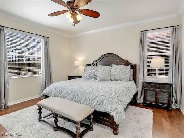 bedroom featuring hardwood / wood-style floors, ceiling fan, and crown molding