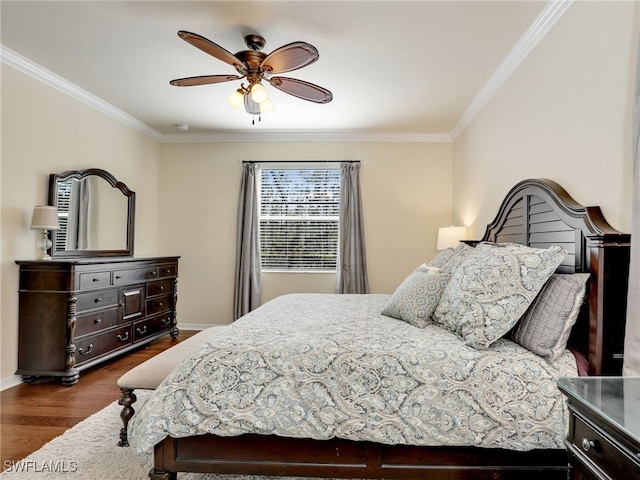 bedroom with dark hardwood / wood-style flooring, ceiling fan, and crown molding