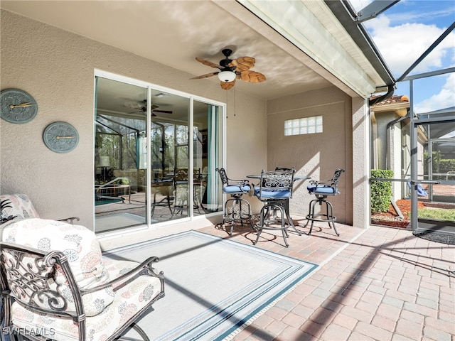 view of patio / terrace with a lanai and ceiling fan