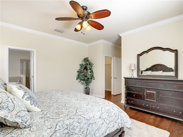 bedroom featuring ceiling fan, ensuite bathroom, crown molding, and dark wood-type flooring