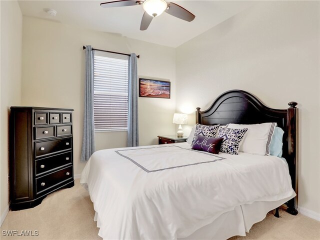 bedroom featuring light colored carpet and ceiling fan