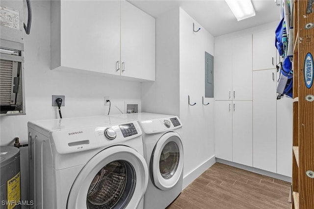 laundry area featuring washer and clothes dryer, cabinets, and electric panel