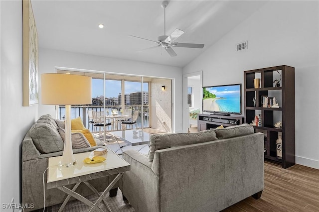 living room featuring ceiling fan, vaulted ceiling, and hardwood / wood-style flooring