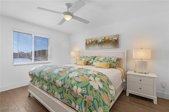 bedroom with ceiling fan and dark hardwood / wood-style flooring