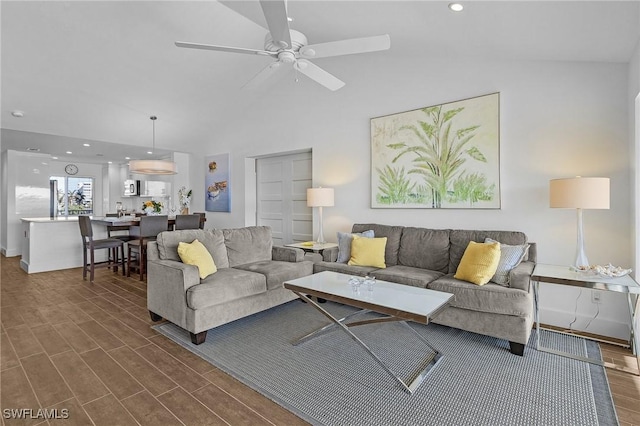 living room featuring dark wood-type flooring, ceiling fan, and lofted ceiling