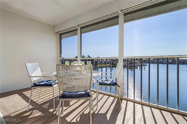 sunroom / solarium featuring a water view