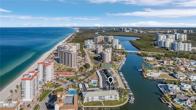 bird's eye view featuring a water view and a beach view