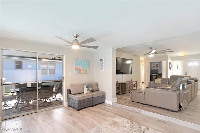 living room with light wood-type flooring and ceiling fan