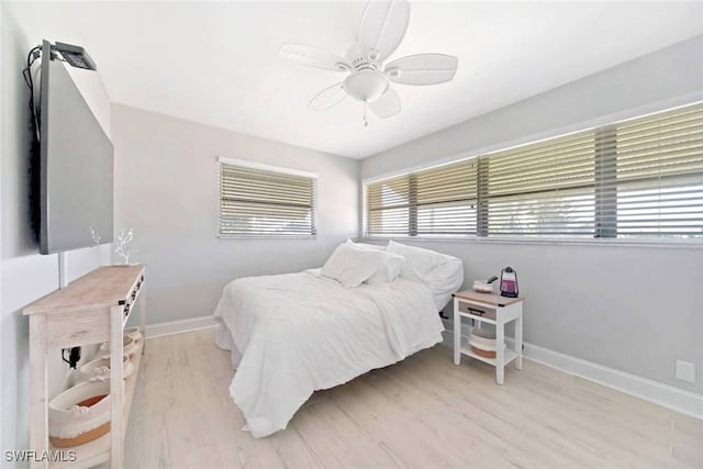 bedroom with light hardwood / wood-style flooring and ceiling fan