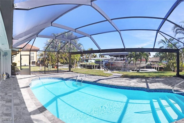 view of pool with a patio and glass enclosure