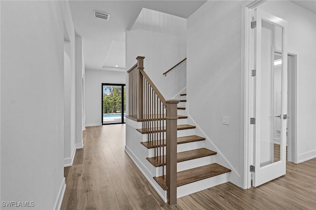 staircase with wood-type flooring