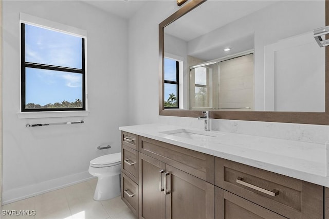 full bath with vanity, tile patterned flooring, toilet, a stall shower, and baseboards