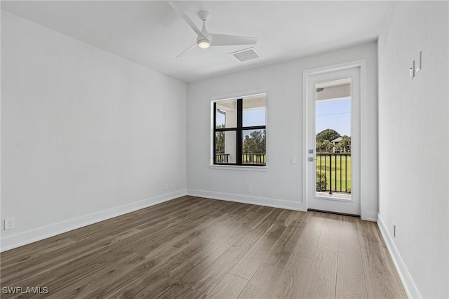 unfurnished room featuring ceiling fan, baseboards, and wood finished floors