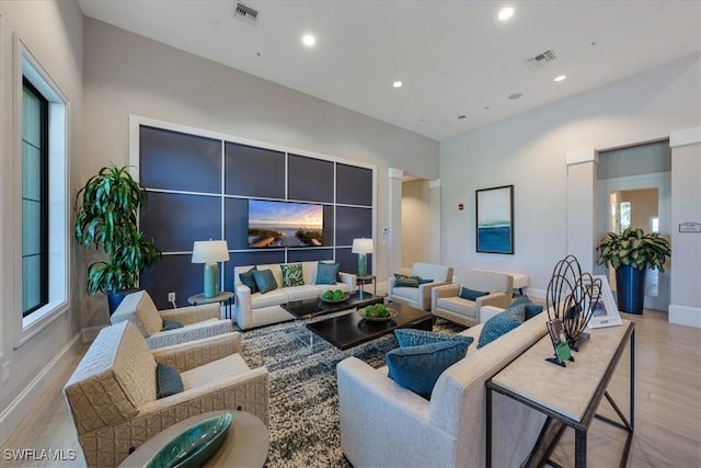 living room with a healthy amount of sunlight and light hardwood / wood-style floors