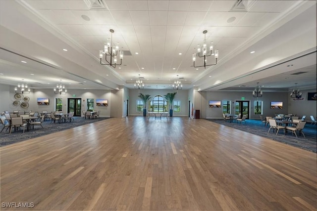 workout area featuring wood-type flooring and ornamental molding