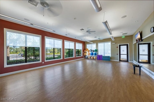 interior space with hardwood / wood-style flooring, ceiling fan, and a wealth of natural light