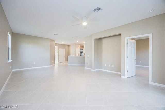 unfurnished living room with ceiling fan and light tile patterned flooring