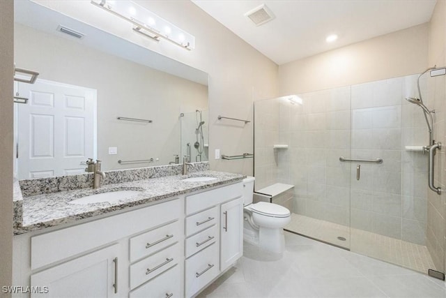 bathroom featuring tile patterned flooring, vanity, a shower with shower door, and toilet