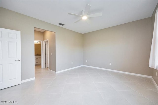 tiled empty room featuring ceiling fan