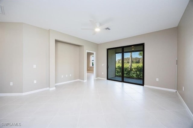 tiled empty room featuring ceiling fan