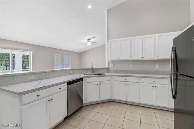 kitchen featuring light stone countertops, kitchen peninsula, stainless steel dishwasher, sink, and fridge