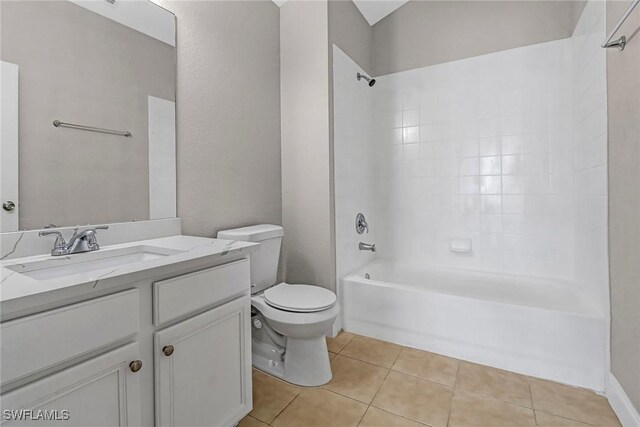 full bathroom featuring tile patterned flooring, vanity, tiled shower / bath combo, and toilet