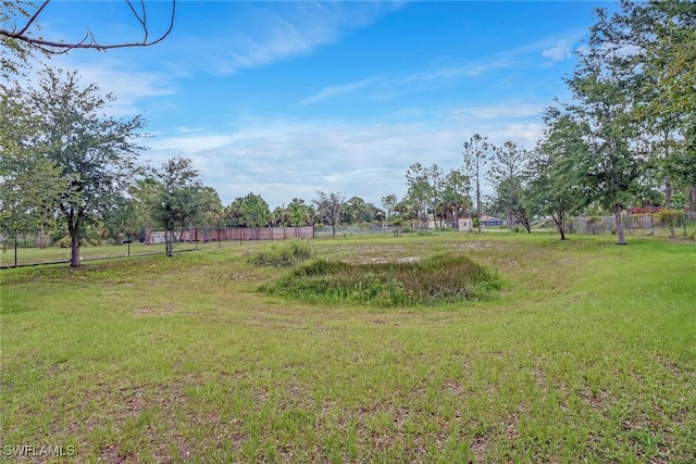 view of yard featuring a rural view and fence