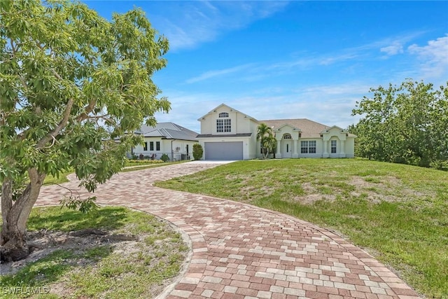 ranch-style home with a front yard and a garage