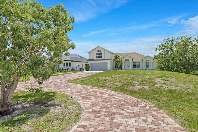 4490 10th St NE, Naples, FL 34120 - view of front of house with an attached garage, decorative driveway, a front lawn, and stucco siding