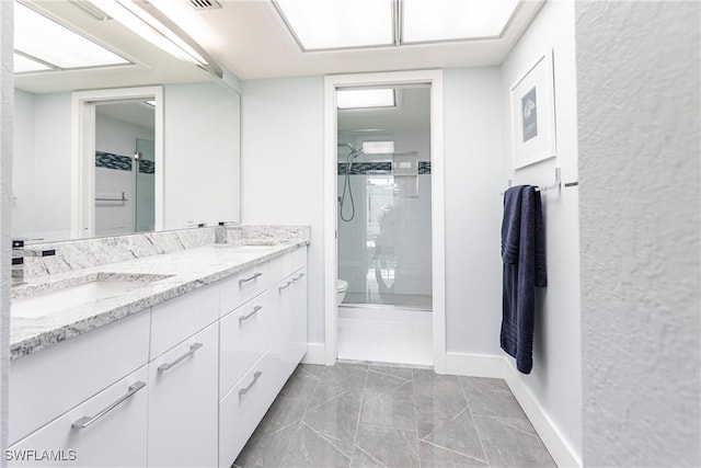 bathroom with toilet, an enclosed shower, and vanity