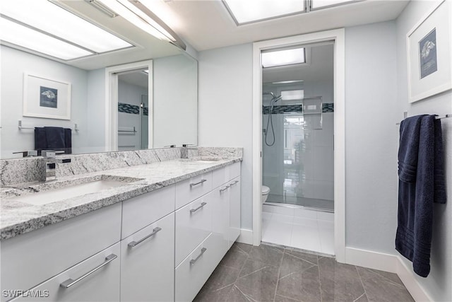 bathroom featuring toilet, tile patterned flooring, an enclosed shower, and vanity