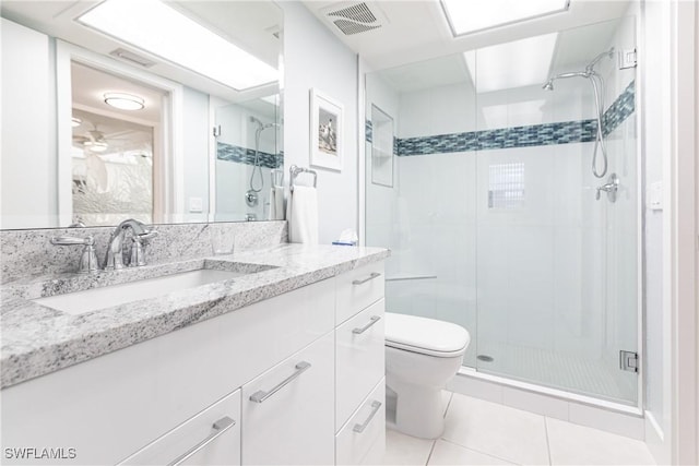 bathroom with toilet, tile patterned floors, a shower with shower door, and vanity