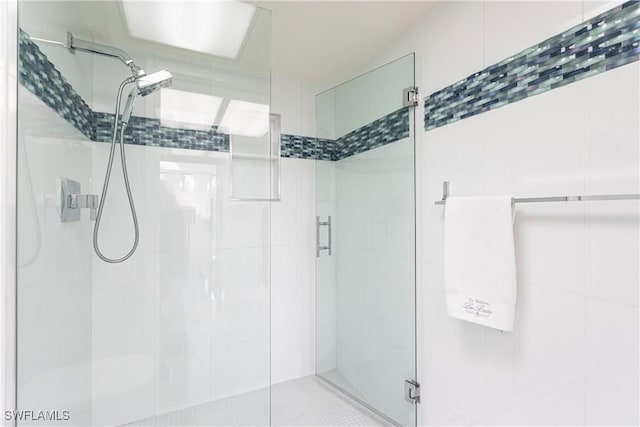 bathroom with a shower with shower door